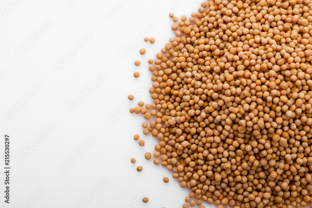 fragrant grains of mustard on a white background fragrant grains of mustard on a white background