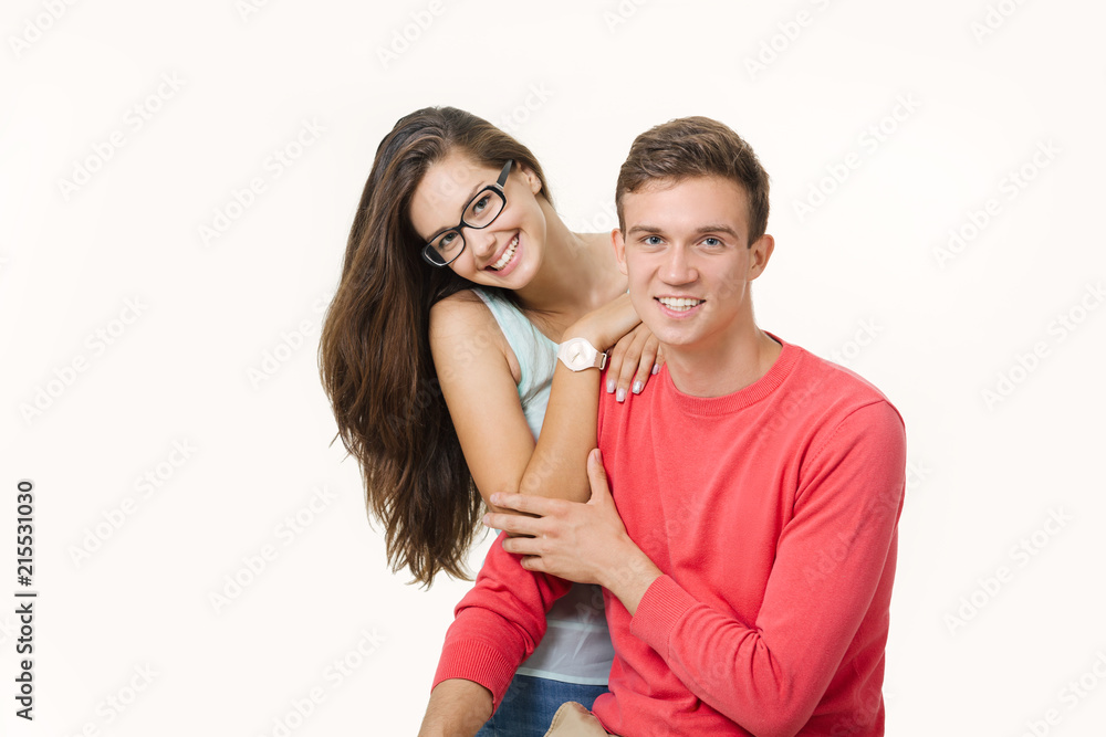 Happy lovely couple hugging and smiling looking at camera on white background Happy lovely couple hugging and smiling looking at camera on white background