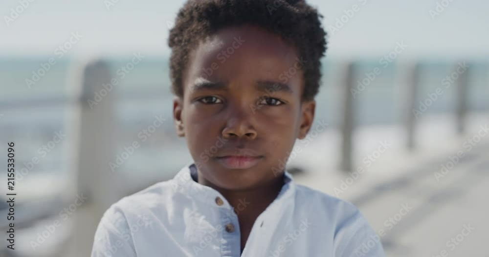 portrait angry african american boy looking unhappy arms crossed little kid tantrum on sunny seaside slow motion portrait angry african american boy looking unhappy arms crossed little kid tantrum on sunny seaside slow motion