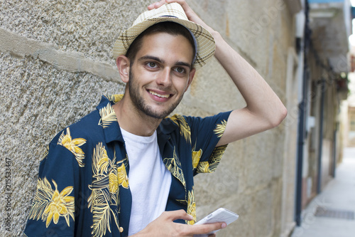 young fashion with mobile phone on the street from the open air city photo