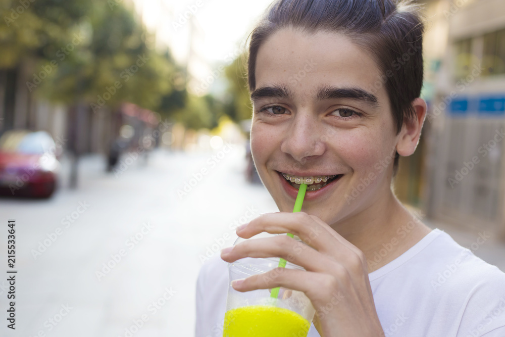 portrait of young teenager drinking soda on the street portrait of young teenager drinking soda on the street