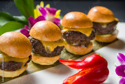 Close up shot of 3 sliders on a plate