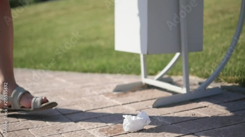 Wallpaper Mural Garbage lies near the urn. A young girl takes the garbage out of the urn Torontodigital.ca