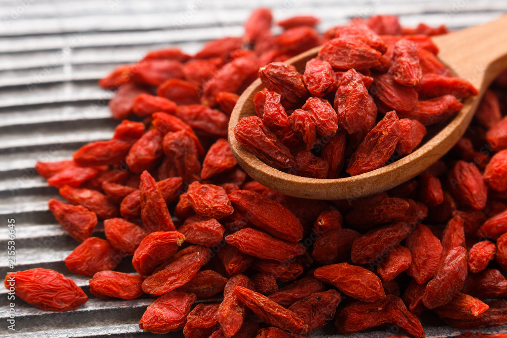 dried goji berries on a wooden rustic background dried goji berries on a wooden rustic background