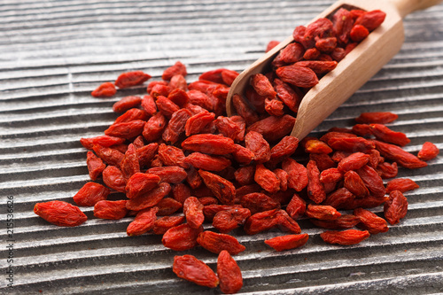 dried goji berries on a wooden rustic background © Narsil