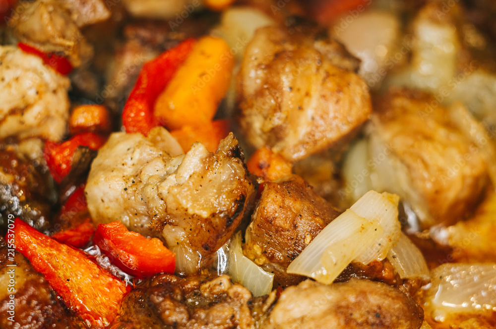 Roast meat, onions, carrots and spices, boiling in oil Roast meat, onions, carrots and spices, boiling in oil