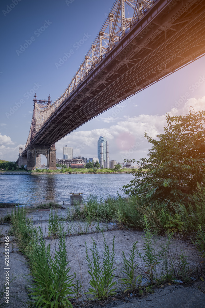 57th street bridge in NYC with cloudy blue sky