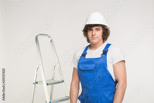 Construction, building and workers concept - Closeup portrait of caucasian male builder in white helmet.