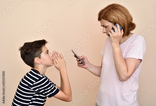 Canvas Print Son begging his angry and nervous mother for attention