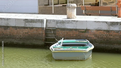 moored boat in the Leonardesque canal port in Italy photo