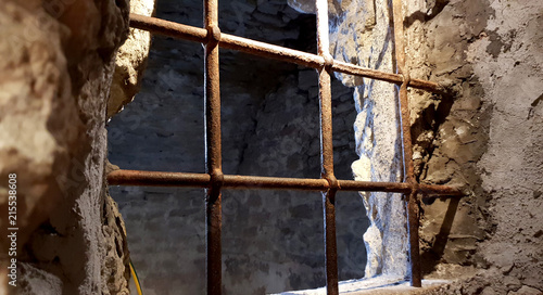 Ancient terrifying jails in italian castle with views through the bars
