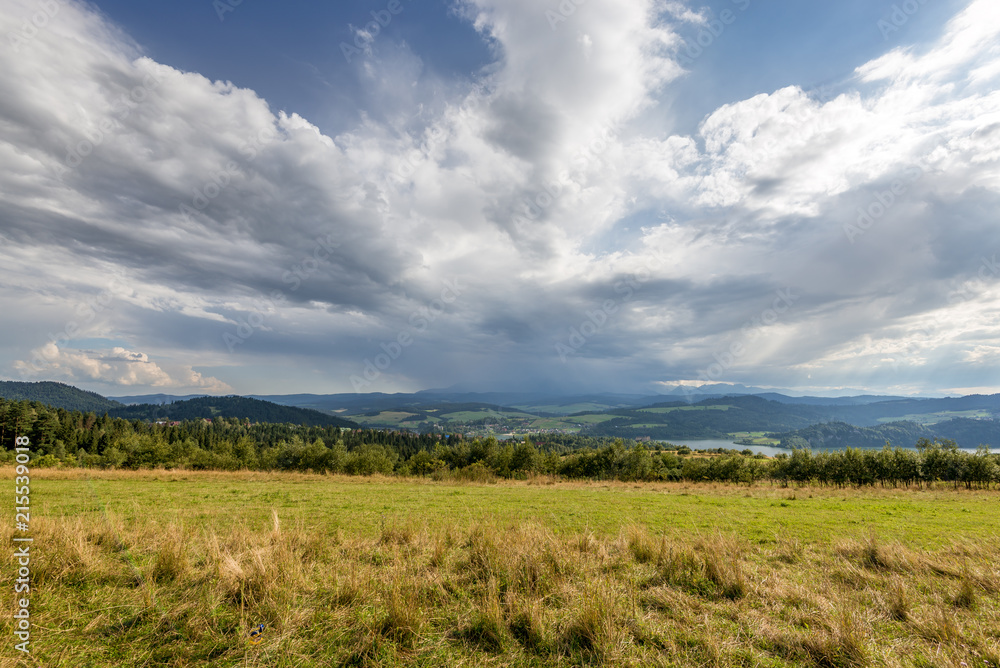 Rural scenery. Fields, mountains with amazing clouds on the sky. Pieniny National Park. Malopolska, Poland.