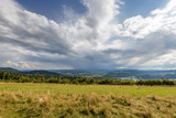 Rural scenery. Fields, mountains with amazing clouds on the sky. Pieniny National Park. Malopolska, Poland.