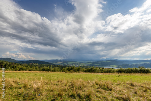 Rural scenery. Fields  mountains with amazing clouds on the sky. Pieniny National Park. Malopolska  Poland.