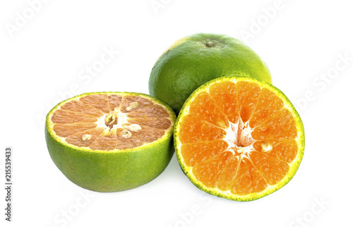 green tangerine on white background.