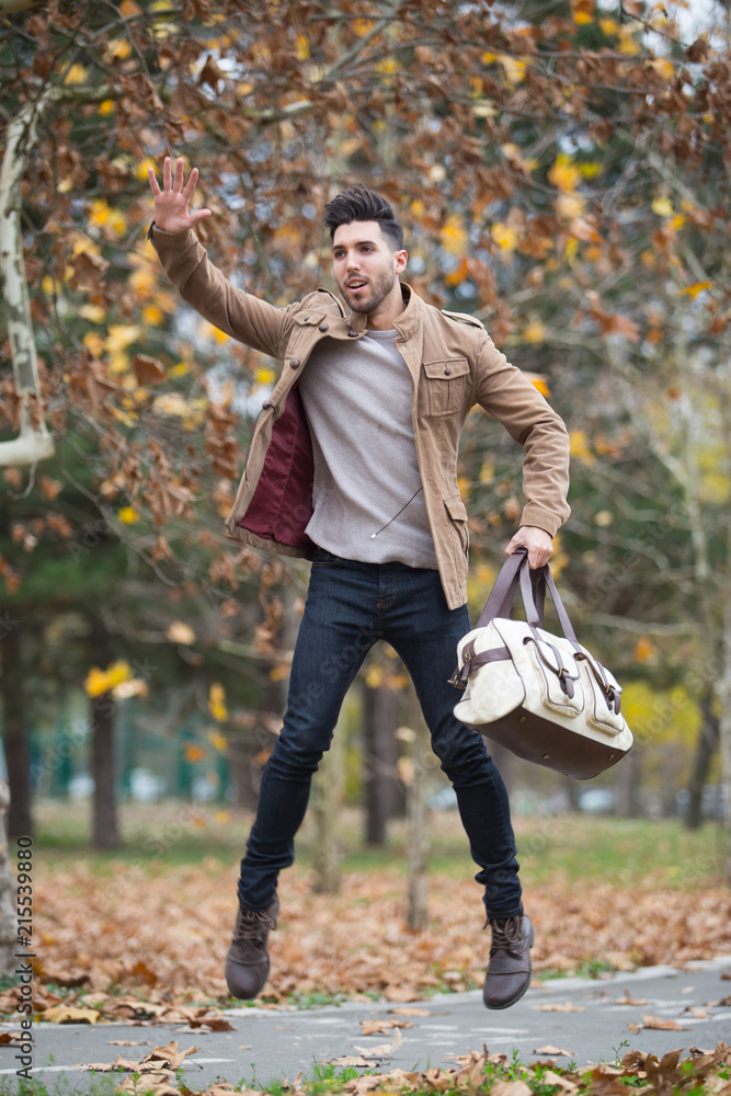 Young adult man handsome jumping in the wood, winter autumn day Young adult man handsome jumping in the wood, winter autumn day