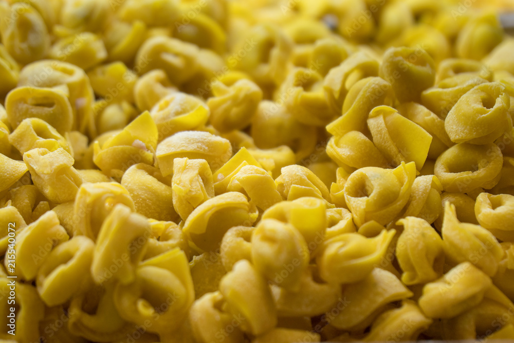 Fresh and uncooked tortellini, a traditional pasta from Bologna and Modena, Italy Fresh and uncooked tortellini, a traditional pasta from Bologna and Modena, Italy