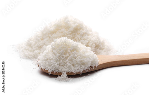 Pile of shredded coconut meat with wooden spoon isolated on white background