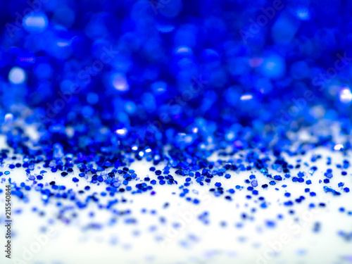 Blue sparkling glitter bokeh background.