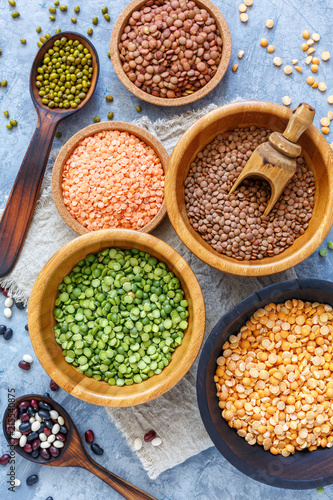 Green and yellow peas, mung and lentils in bowls.