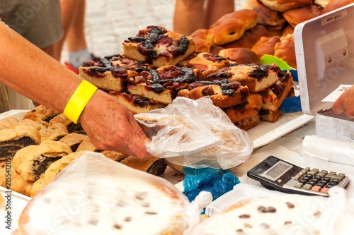 Fresh pastries for sale in a bakery. Sales of different types of cakes in the farmers' markets. Sweet pastry at the market. Apricot, poppy, marmalade and fruit cakes.