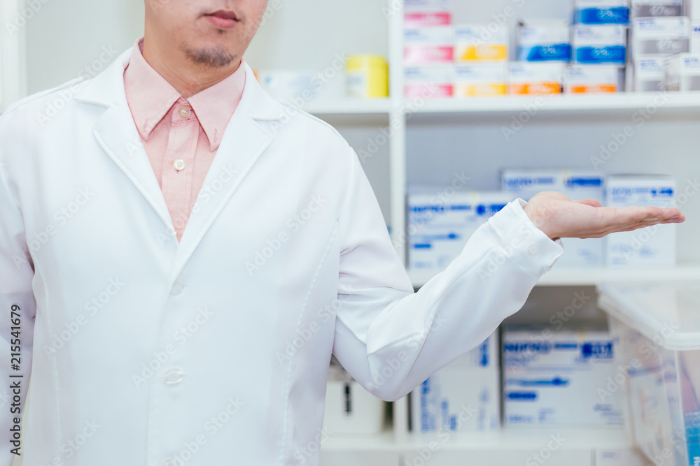 Pharmacist putting hands with copy space on palm in medicine store room background - used to display medical products or insert any text. Pharmacist putting hands with copy space on palm in medicine store room background - used to display medical products or insert any text.
