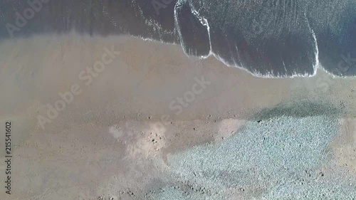 Aerial bird eye rocket view of dark ocean beach wave in Japan. photo