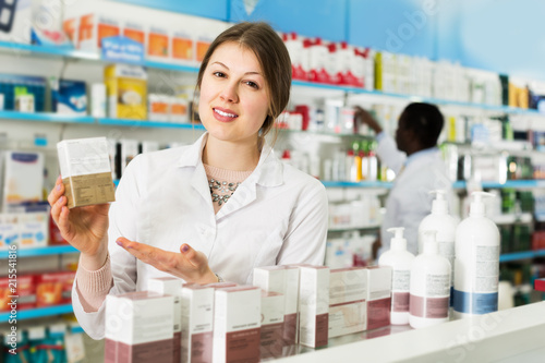 Female pharmacist offering medication