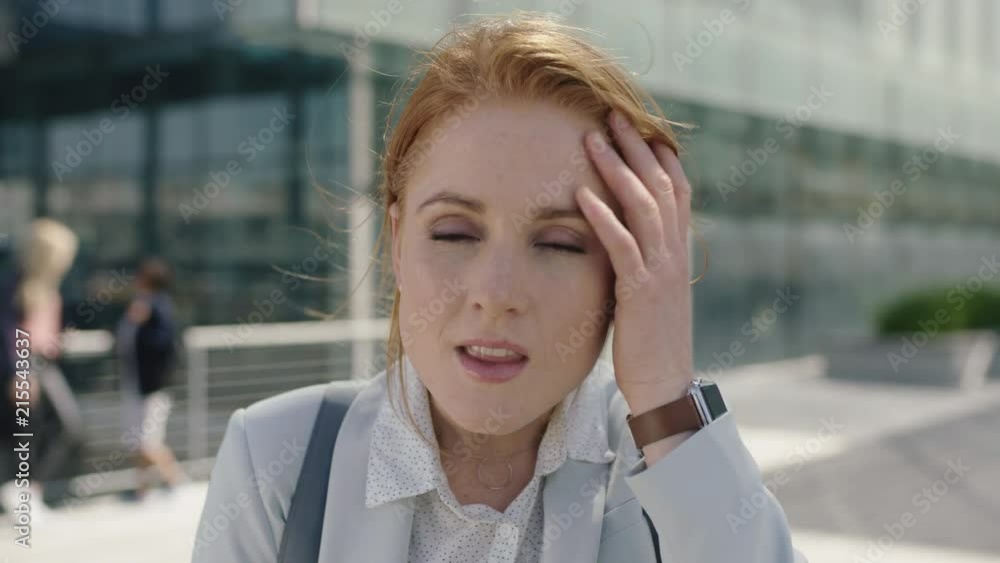 close up portrait of beautiful red head business woman intern smiling friendly running hand through hair enjoying lunch break close up portrait of beautiful red head business woman intern smiling friendly running hand through hair enjoying lunch break