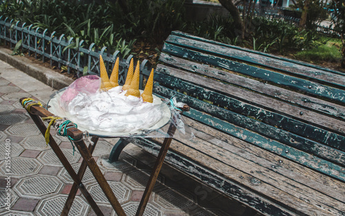 Ecuadorian street food stand by a park bench for traditional guanaba and strawberry flavored Espumilla, a meringue cream similar to ice cream that doesn't melt photo