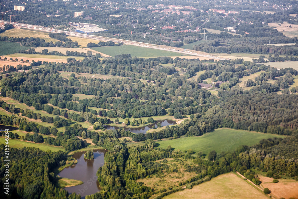 Aerial top view of forest, lake, road and city near Kiev, Ukraine