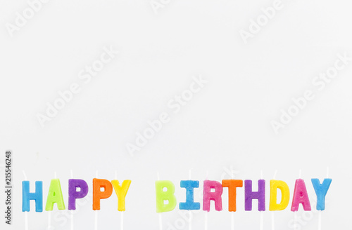 Colorful letter candles, Happy Birthday candles on grey background with copy space. Happy Birthday concept or background
