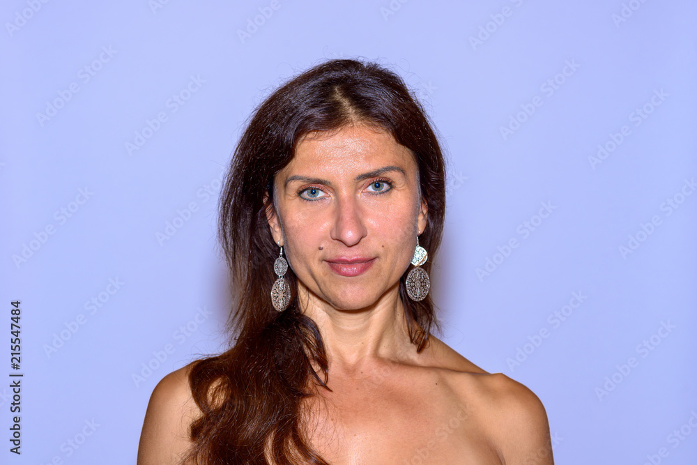Woman with bare shoulders on blue background Woman with bare shoulders on blue background