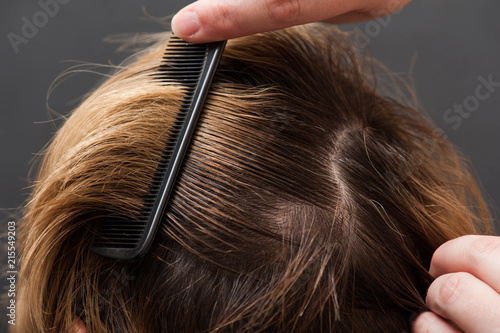 Combing blond hair with brush