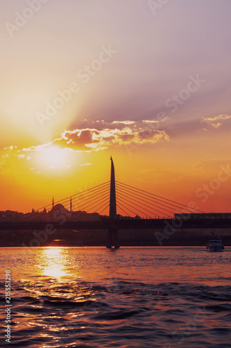 Sunset in Istanbul  Turkey. View of the mosque and the bridge.