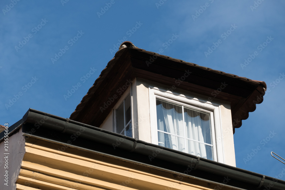 detail of a window on a roof of an old house