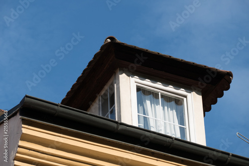 detail of a window on a roof of an old house