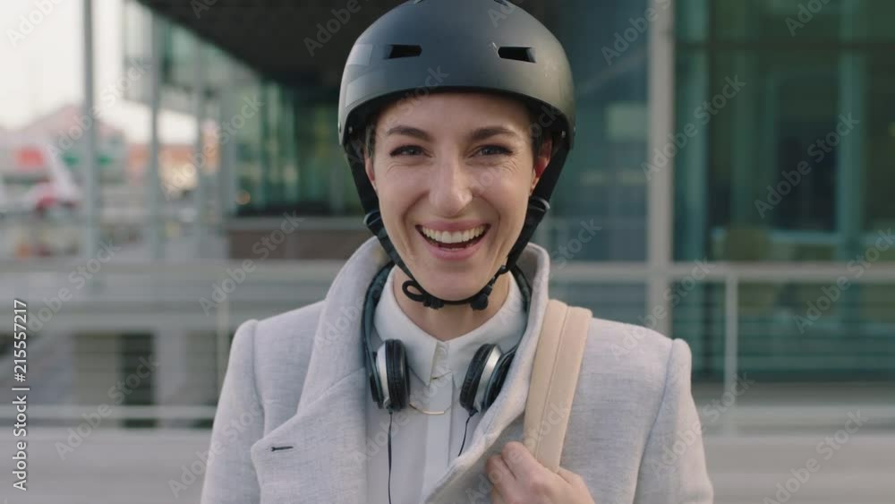 portrait of cheerful young business woman intern wearing bicycle safety helmet laughing happy enjoying new corporate career in city portrait of cheerful young business woman intern wearing bicycle safety helmet laughing happy enjoying new corporate career in city