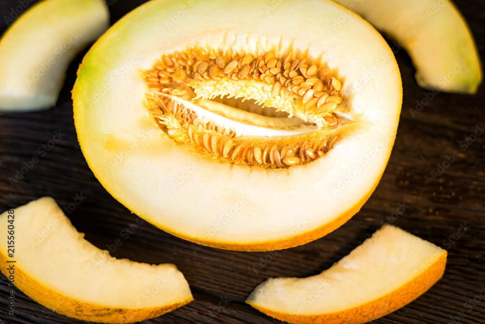 Fresh half of melon on wooden background, top view Fresh half of melon on wooden background, top view