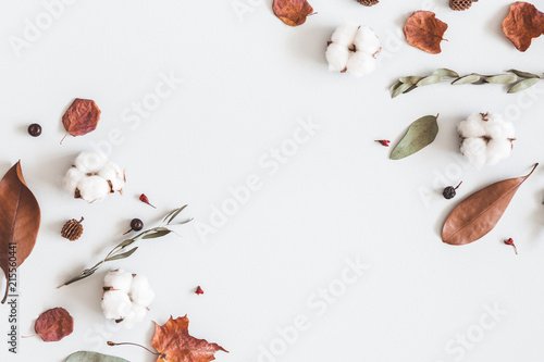 Autumn composition. Frame made of eucalyptus branches, cotton flowers, dried leaves on pastel gray background. Autumn, fall concept. Flat lay, top view, copy space