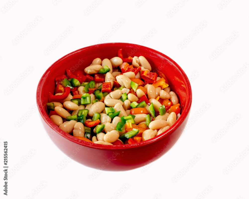 Navy beans and bell peppers in red bowl isolated on white Navy beans and bell peppers in red bowl isolated on white