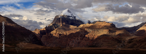 Mount Kailash, Kangrinboqe peak. Ngari, Tibet Autonomous Region of China. Panoramic view with Sunset, dramatic lighting, snow mountain peaks illuminated. Tibetan pilgrimage site, Sacred Mountain