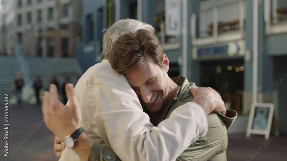 family reunion portrait of elderly father and adult son smiling happy embracing hugging enjoying vacation together family reunion portrait of elderly father and adult son smiling happy embracing hugging enjoying vacation together