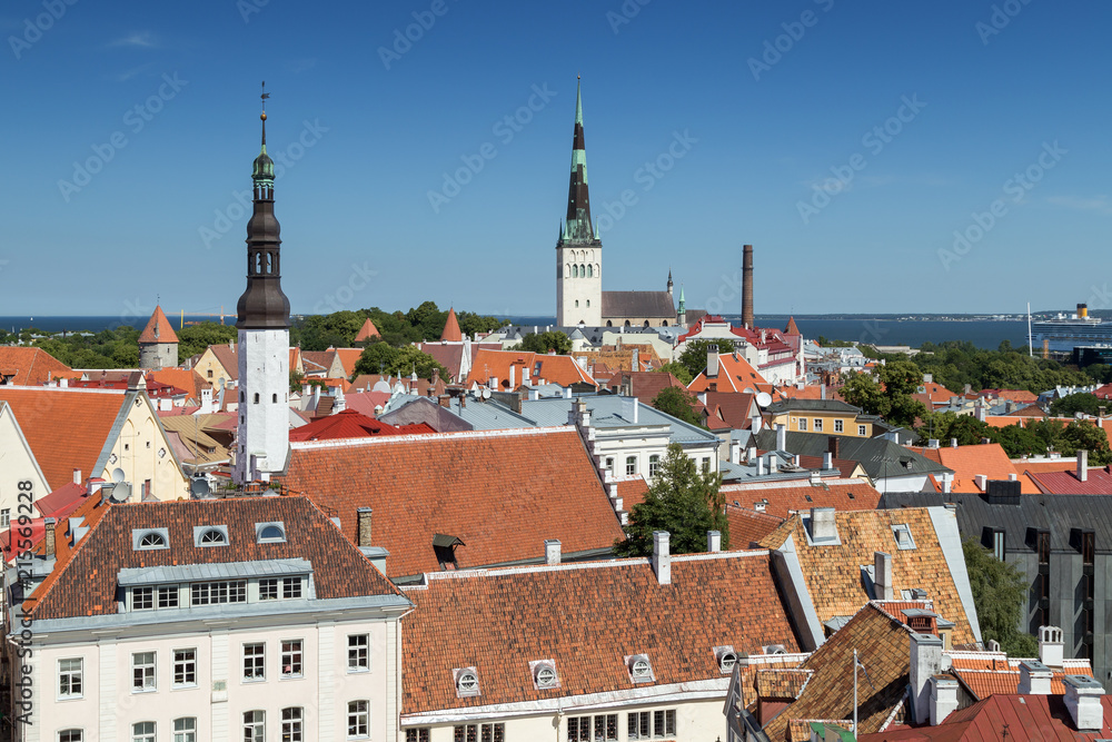 Holy Spirit Church's and St. Olaf's (or Olav's) church's towers and other old buildings at the Old Town in Tallinn, Estonia, viewed from above on a sunny day in the summer.