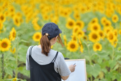 ひまわりと女性とキャンバス 