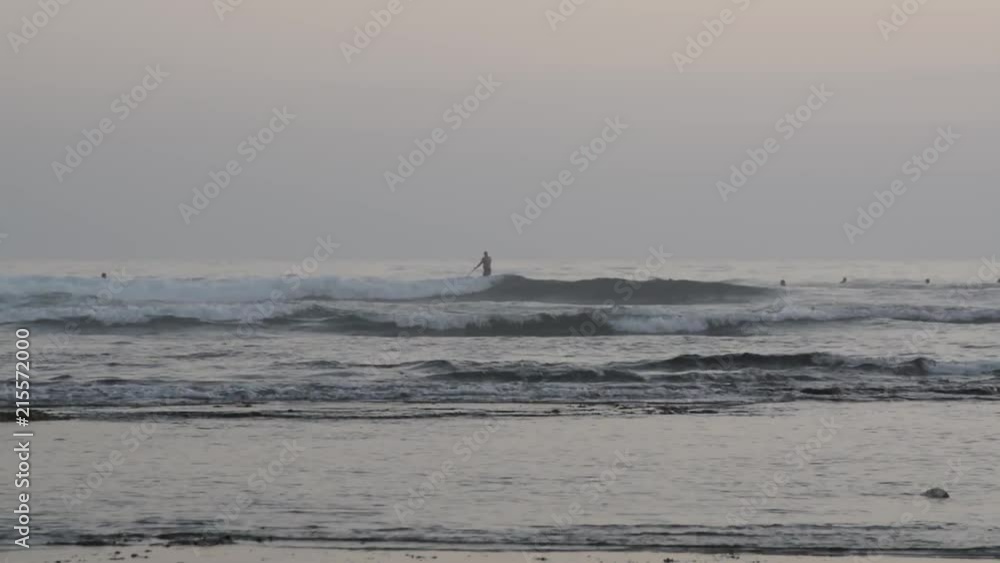 surfers in the water in Ribeira de Ilhas beach in Ericeira surfers in the water in Ribeira de Ilhas beach in Ericeira
