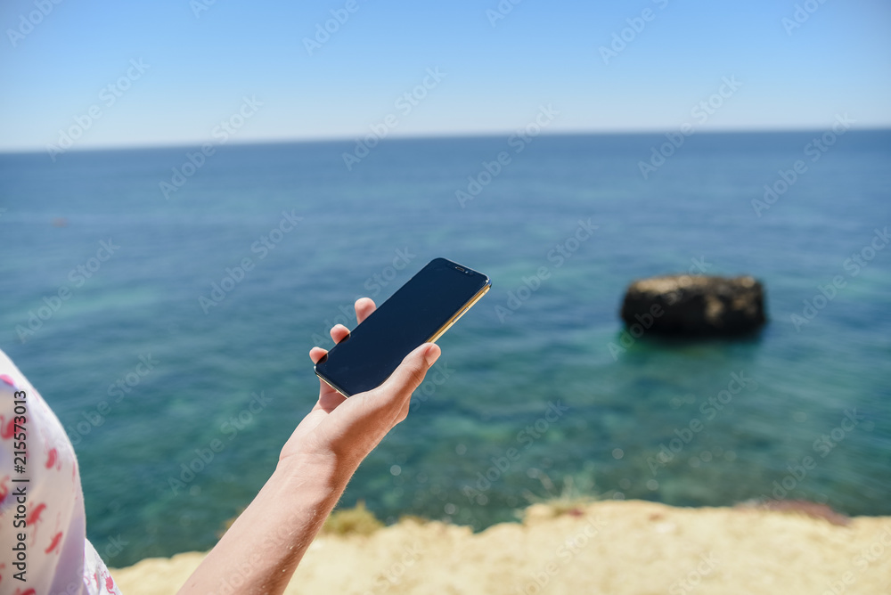 Man holding mobile phone nature blue sky outdoors. Closeup on handsome person use wireless digital smartphone device, modern design, communication technology lifestyle.