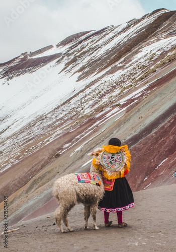 Photos Young indigenous Peruvian girl stands in traditional Quechua dress with her pet