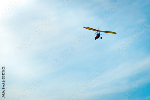 Glider high in the sky. Glider on a blue sky background.