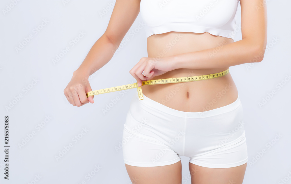 Measuring tape, stomach and woman in studio for wellness, weight